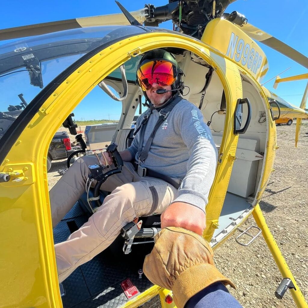 Damien O'Halloran co-owner and assistant chief pilot of Rotor Power seated in helicopter cockpit preparing for flight
